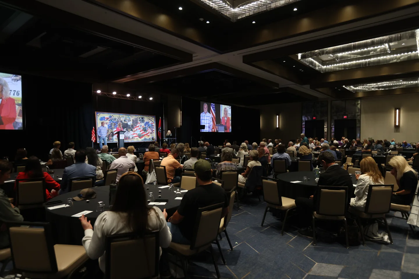 Attendees seated together at tables facing the stage at the 2026 Ignite Kingdom Conference